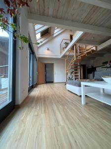 a large room with a staircase and a living room at Ferienwohnung mit Balkon in Oberelsbach