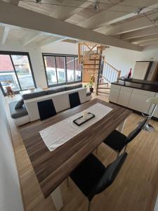 a living room with a table and a couch at Ferienwohnung mit Balkon in Oberelsbach