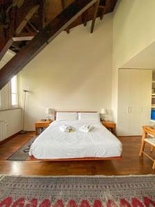 a bedroom with a white bed and a rug at Passeig de Gracia Studio Loft in Barcelona