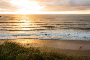 a group of people in the water at the beach at Newquay Horizons in Newquay