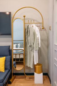 a dressing room with a mirror and a blue couch at Apart Hotel Console in Tbilisi City