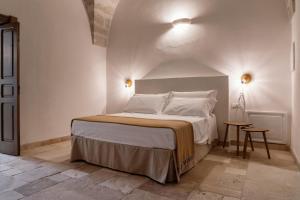a bedroom with a large bed in a room at Masseria Gorgognolo in Ostuni