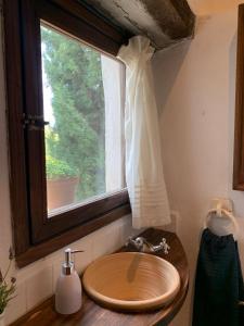 a bathroom with a sink and a window at Casas de Almajar in Prado del Rey