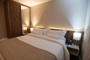 Cama ou camas em um quarto em Intercity BH Expo