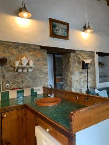 a kitchen with a counter with a sink in it at Casas de Almajar in Prado del Rey