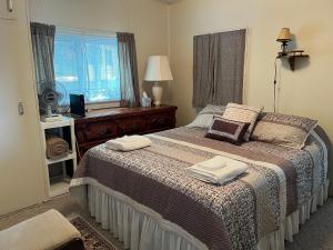 a bedroom with a bed with two towels on it at Paradise Cottage C2 in Greenville