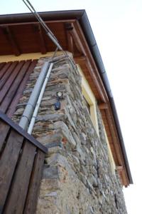 a stone building with a window on the side of it at Cà de sass 1891 in Vezzo