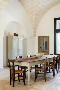 a dining room with a table and chairs at Masseria Gorgognolo in Ostuni