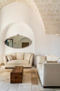 a living room with a couch and a table at Masseria Gorgognolo in Ostuni