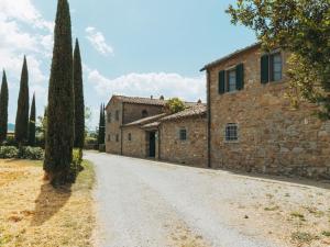 an empty road in front of an old stone building at Rustic Farmhouse in Cortona with Swimming Pool in Cortona