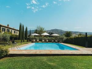 a swimming pool in the yard of a house at Rustic Farmhouse in Cortona with Swimming Pool in Cortona