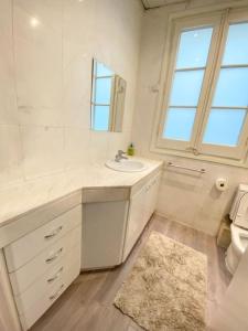 a bathroom with a sink and a toilet and a mirror at Passeig de Gracia Studio Loft in Barcelona +13 photos