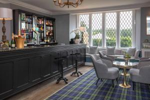 a bar in a pub with chairs and a table at Crewe Hall Hotel & Spa - Cheshire in Crewe