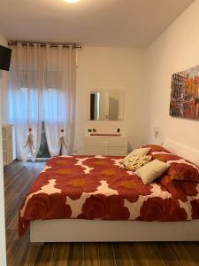 a bedroom with a bed with a comforter at SestoHome26 in Sesto San Giovanni