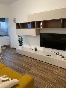 a living room with a large flat screen tv at SestoHome26 in Sesto San Giovanni