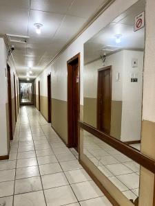 an empty hallway of a building with a mirror at HOTEL AVENIDA in Belém