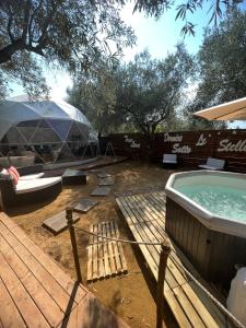 a backyard with a hot tub and a tent at Bubble Glamping Sicily in Catania