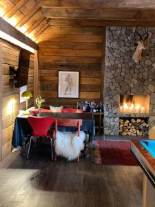 a dining room with a table and a fireplace at Holmsminde in Viborg