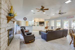 a living room with a couch and a fireplace at Temple Retreat with Cliffside Belton Lake Views! in Temple