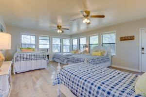 a bedroom with two beds and a ceiling fan at Temple Retreat with Cliffside Belton Lake Views! in Temple