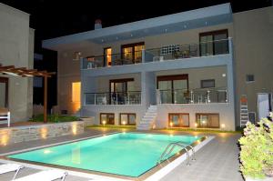 a house with a swimming pool in front of it at Mary's Luxury in Chrysi Ammoudia