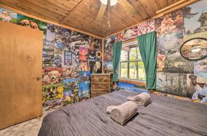 a bedroom with a bed in a room covered in wallpaper at Atlanta Waterfront Cabin with Dock and Kayaks! 