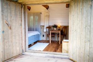 Habitación de madera con cama y mesa en Haanjamehe Taluhotell, en Haanja