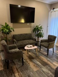 a living room with a couch and two chairs and a table at Why Not Jacuzzi in Arles