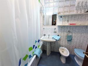 a bathroom with a sink and a toilet at Home in Maccagno con Pino e Veddasca with garden in Maccagno Inferiore