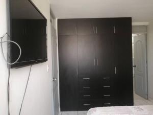 a bedroom with black cabinets and a black closet at Hermoso dpto en la victoria con todos los servicio in La Victoria