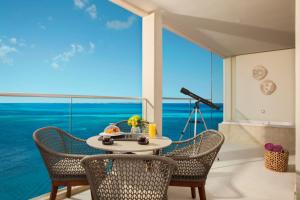 a table in a room with a view of the ocean at Breathless Cancun Soul Resort & Spa - Adults Only - All Inclusive in Cancún