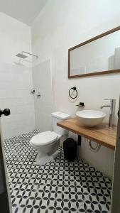 La salle de bains est pourvue de toilettes blanches et d'un lavabo. dans l'établissement Hotel Casa de las Dos Palmas -Hotel Boutique, à Puerto Berrío