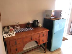 a kitchen with a wooden dresser next to a refrigerator at 30 Oak Street in Greyton