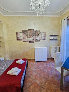 a room with a bed and some pictures on the wall at Bardonecchia Central Studio Apartment - Frejus Palace in Bardonecchia