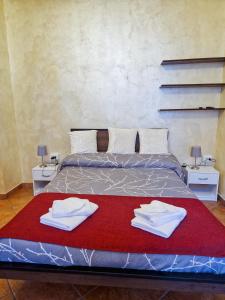 a bedroom with a bed with two towels on it at Bardonecchia Central Studio Apartment - Frejus Palace in Bardonecchia
