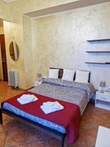 a bedroom with a bed with towels on it at Bardonecchia Central Studio Apartment - Frejus Palace in Bardonecchia