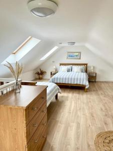 a bedroom with a bed and a dresser in it at Muckish Maison in Dunfanaghy
