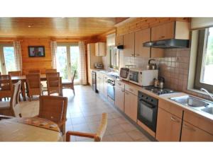 a kitchen and dining room with a table and chairs at Holiday home with a panoramic view of the Ourthe on a quietly located property in La Roche-en-Ardenne