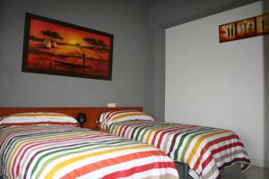 two beds sitting next to each other in a bedroom at Vivienda Turistica Rural Piskerra in Carcastillo
