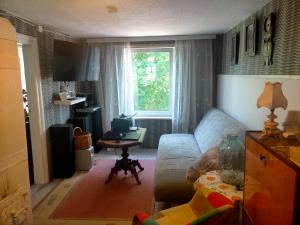 a living room with a couch and a table at Lossi 8-6 Põltsamaa Lonny jõevaatega in Põltsamaa