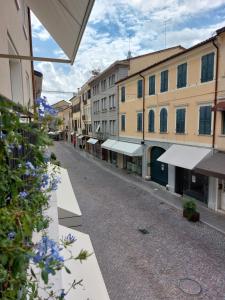 an empty street in a city with buildings at Casa del Corso in Pordenone