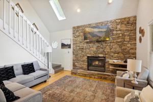 a living room with a fireplace and a stone wall at Valley Heights home in Pigeon Forge