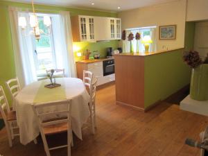 a kitchen and dining room with a table and chairs at Delightful Castle in Bastogne with bubble bath in Bastogne