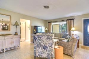 a living room with a couch and a chair at 4 Mi to Dog Beach Largo Home with Pool and Hot Tub! in Largo