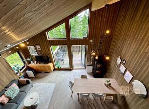 a living room with a table and a couch at Modern ap next to the ski stadium, alpine slope in Sjusjøen