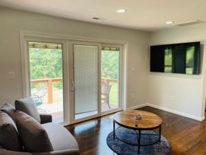 a living room with a couch and a table at Sonsak - Unit 1 in Charlottesville