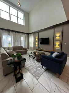 a living room with a couch and a tv at 5bedroom Amazing home close to Disney Resort 8934 in Kissimmee