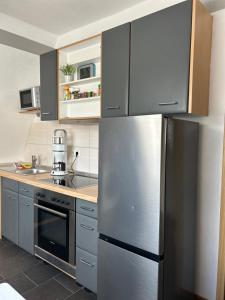 a kitchen with a stainless steel refrigerator at Schöner Wohnen in Bünde in Bünde