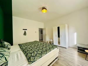 a bedroom with a large bed and a desk at FeWo Ischeland near Hagen-City in Hagen +3 photos