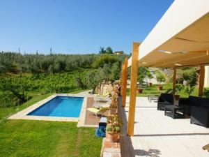 a backyard with a swimming pool and a house at Beautiful Holiday Home in Vinci with Swimming Pool in Vinci